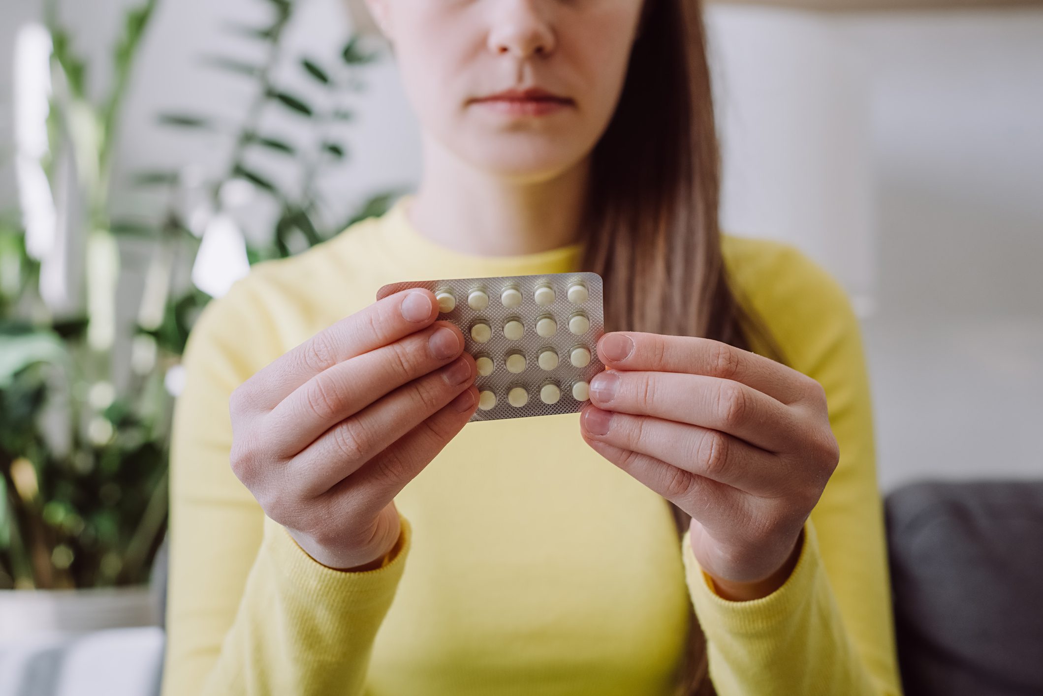 Person holding blister pack of pills.
