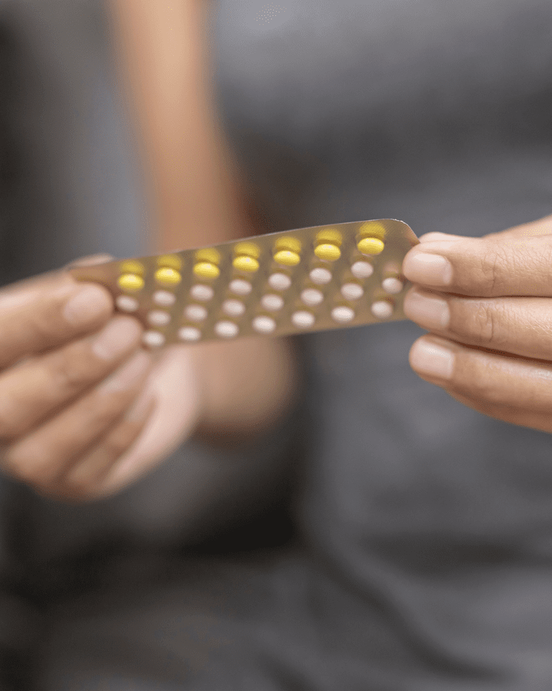 Person holding blister pack of pills.