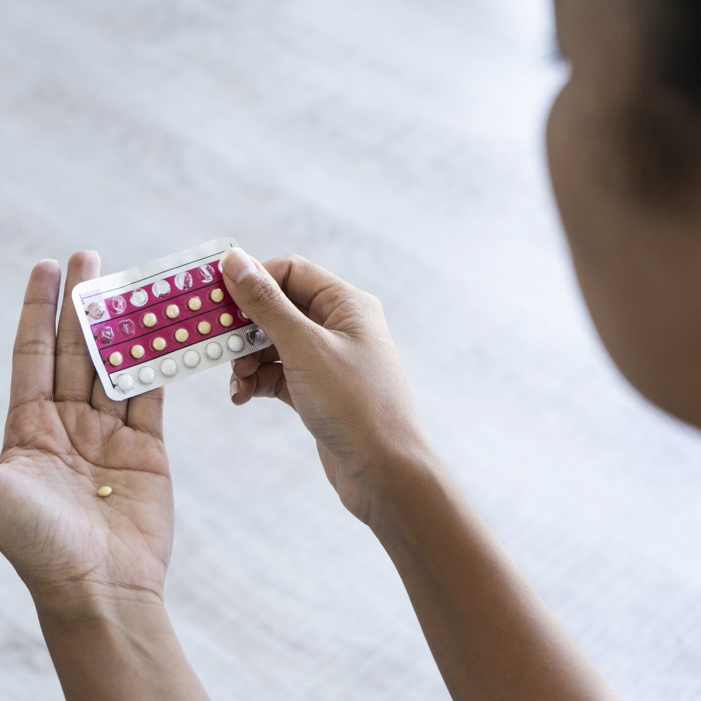 Person holding birth control pill pack.