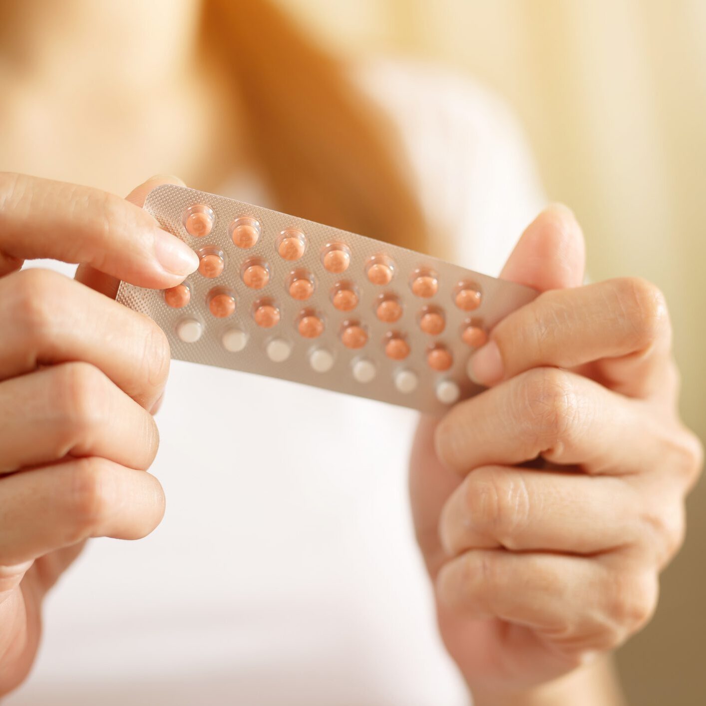 Person holding a blister pack of pills.