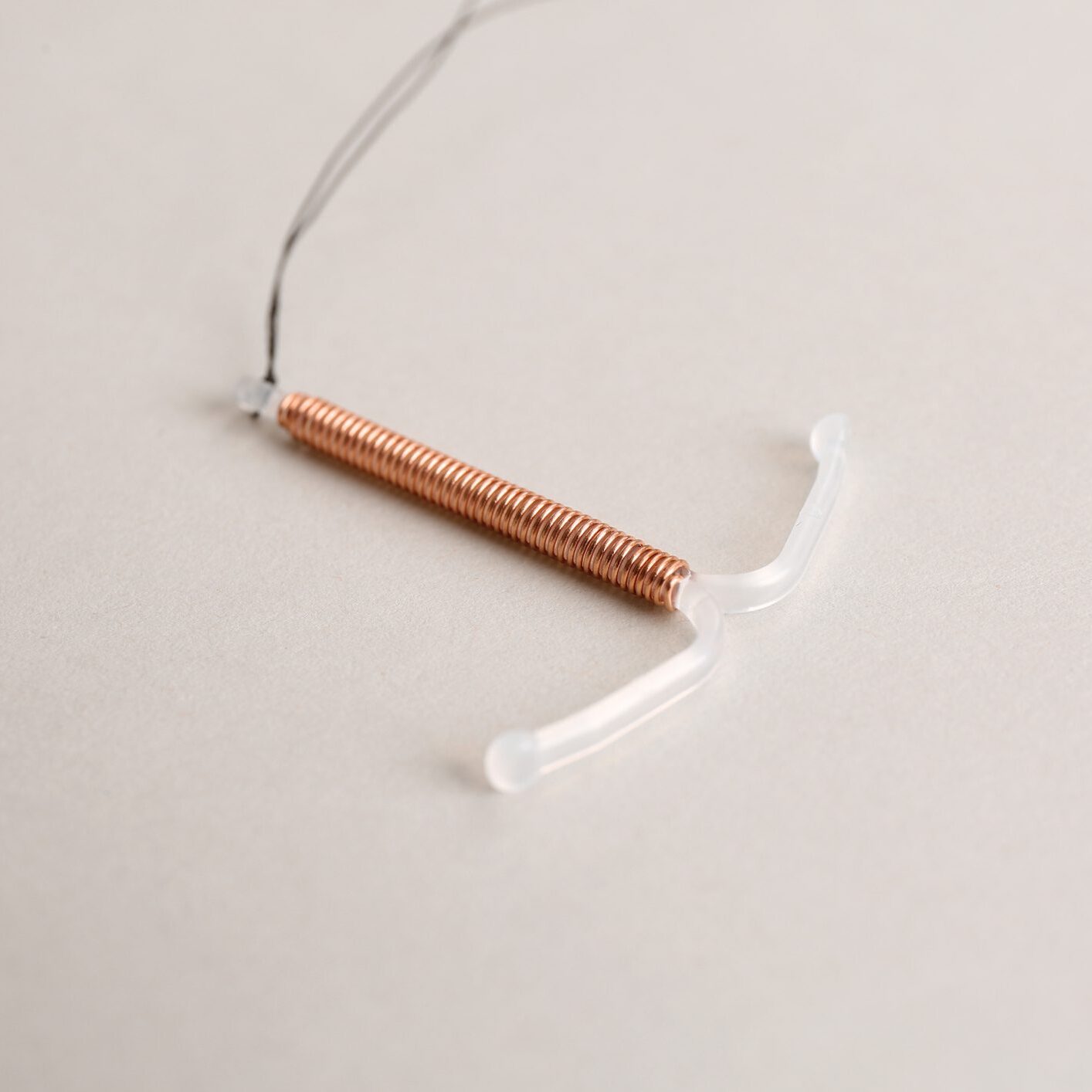Copper IUD on a plain background.