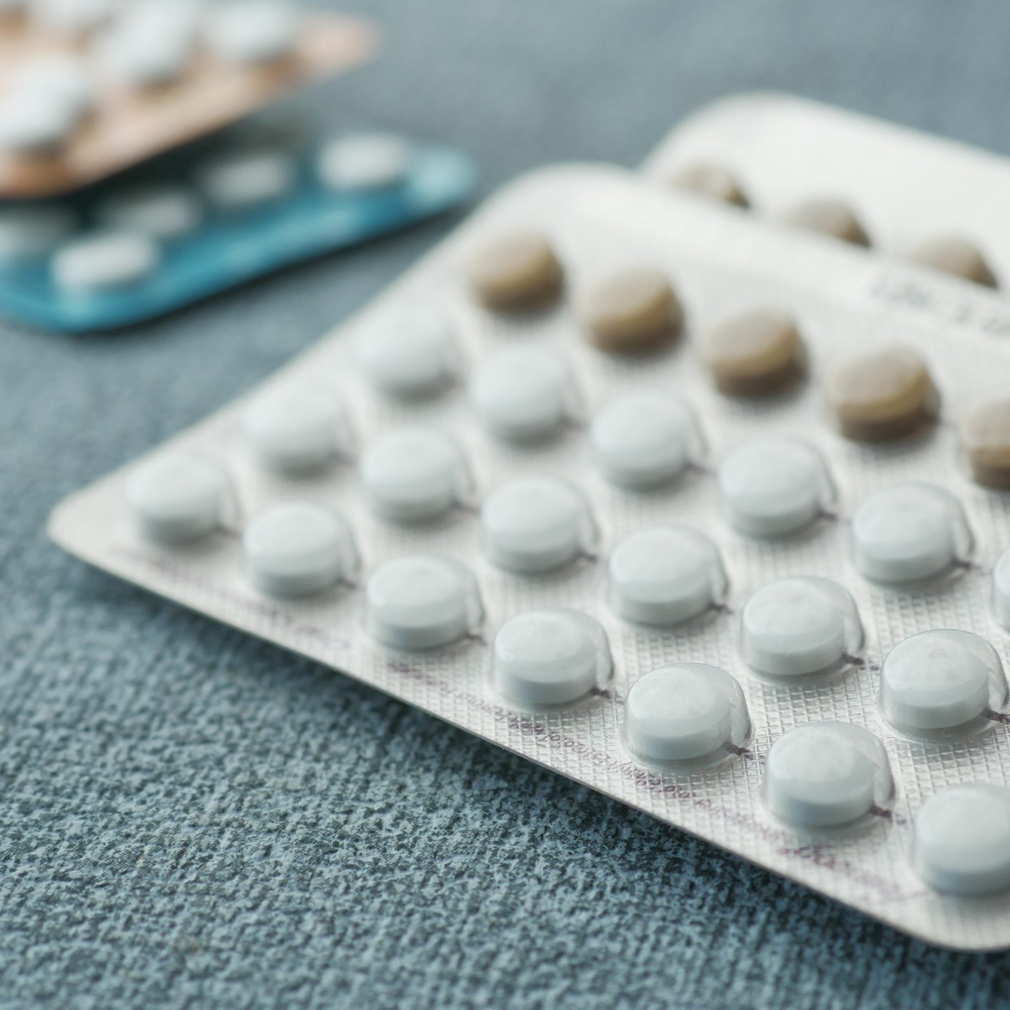 Blister packs of pills on fabric surface.